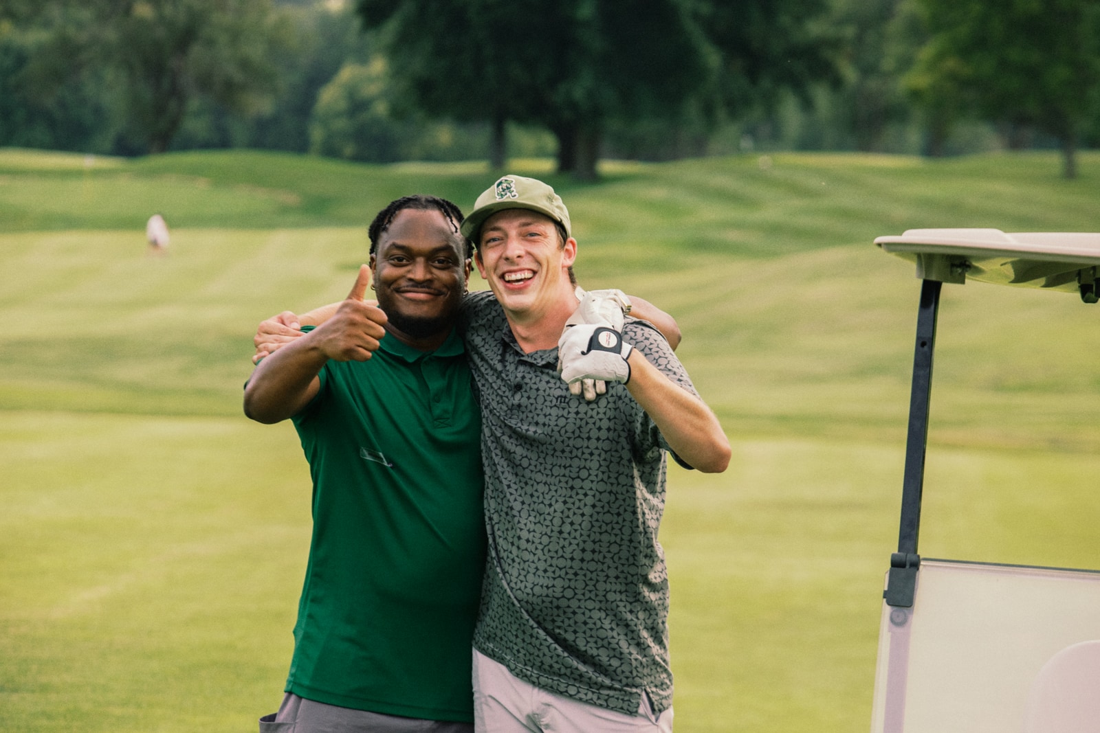 Two league members hugging and grinning after the round