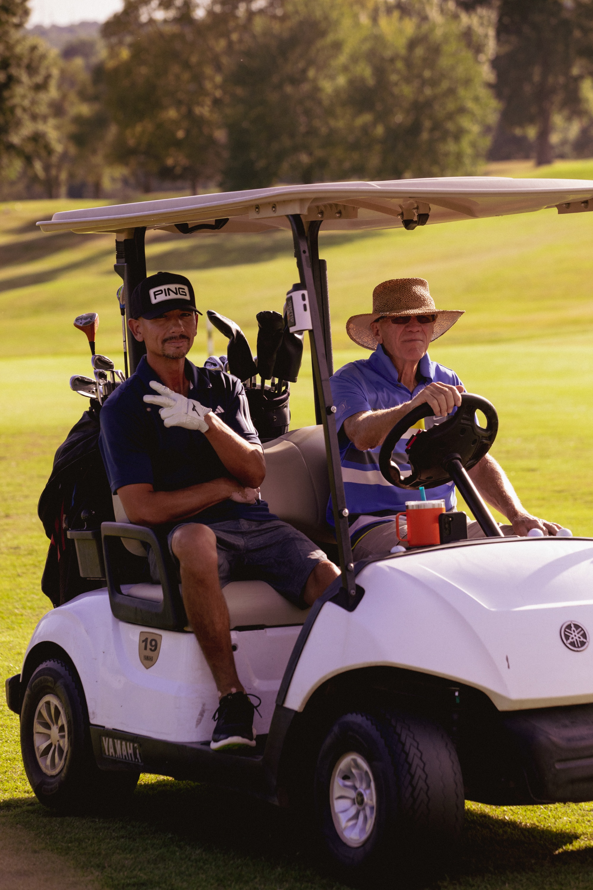 Two guys chilling in a golf cart on the fairway