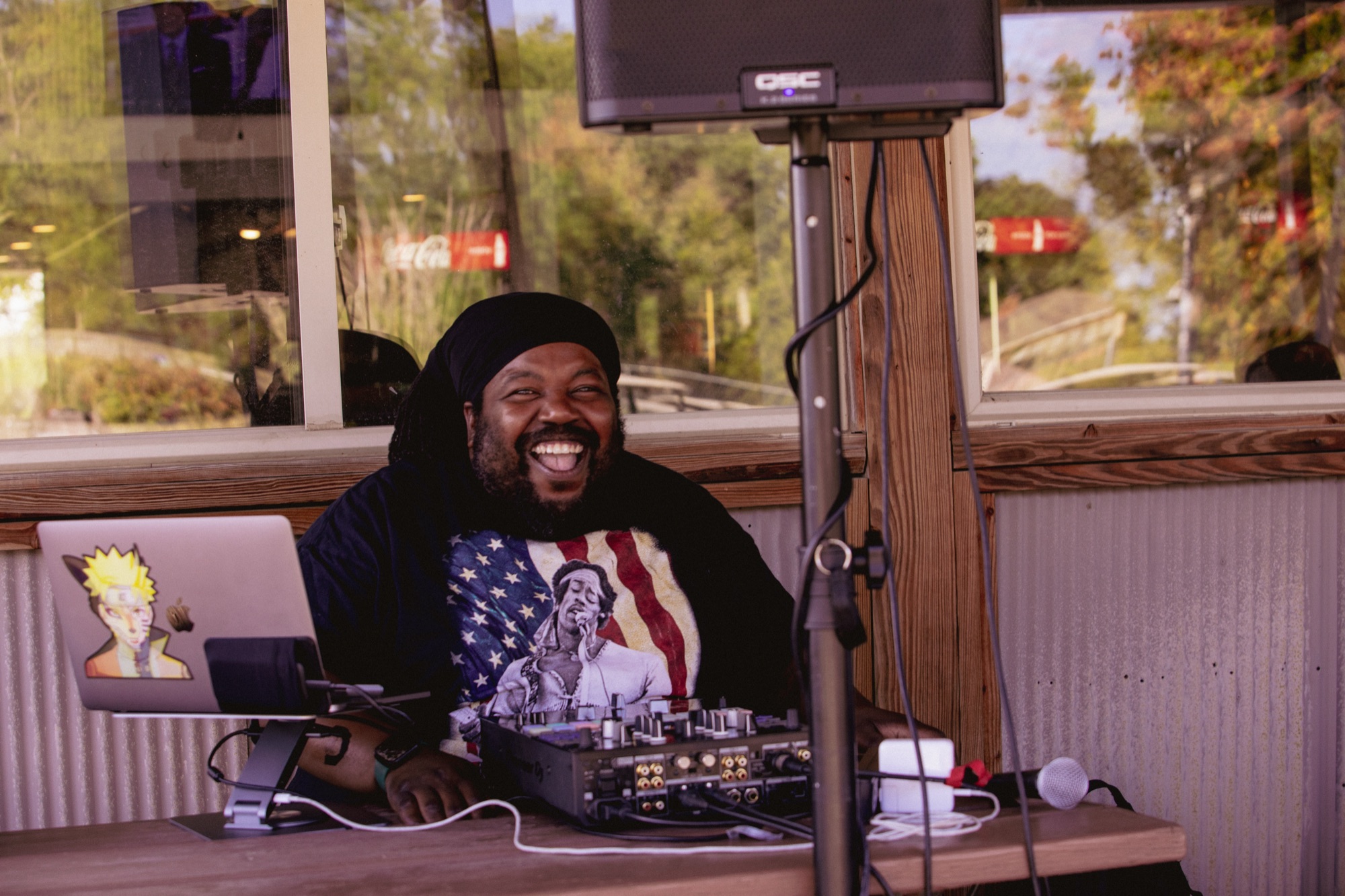 DJ laughing behind his setup at the league night