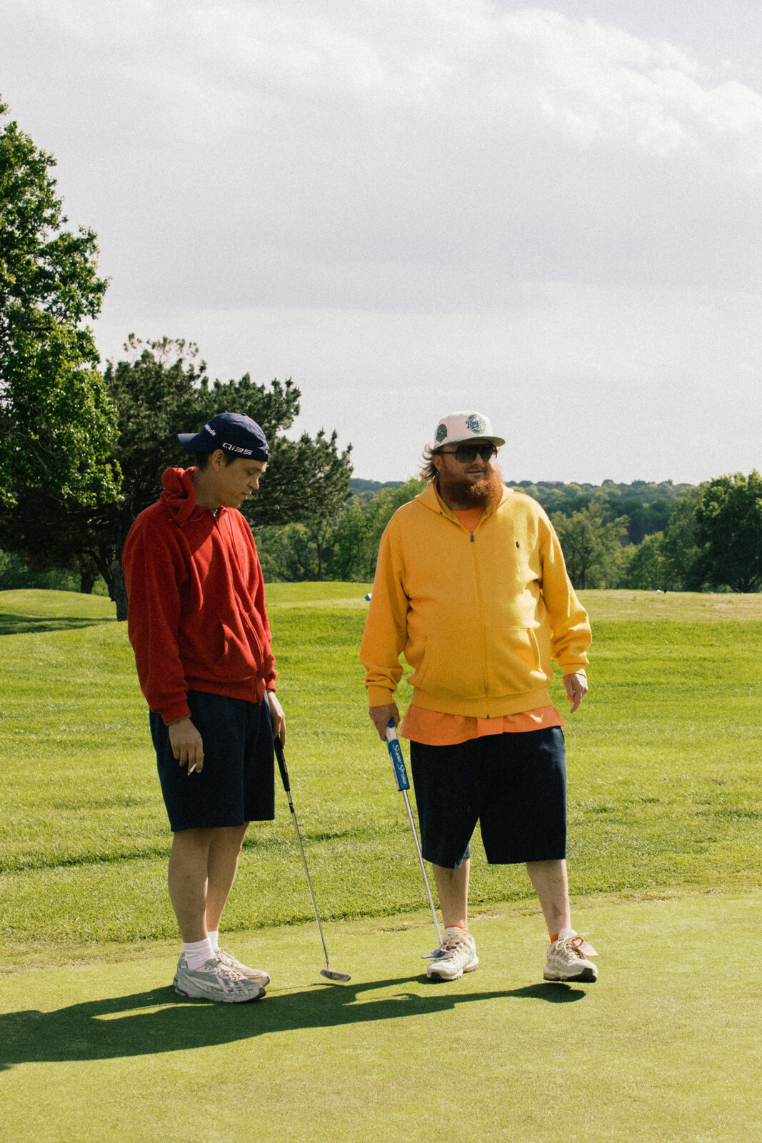 Two league members on the green, red and yellow hoodies