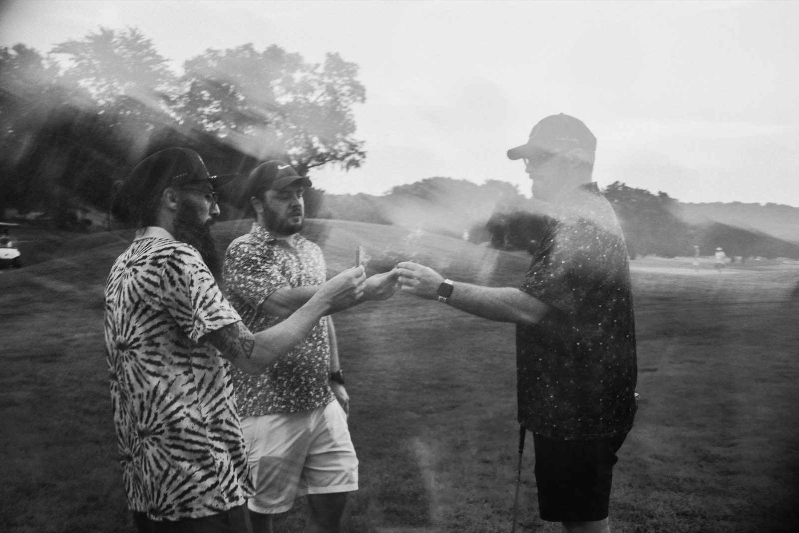Two players in printed shirts meeting on the fairway at dusk
