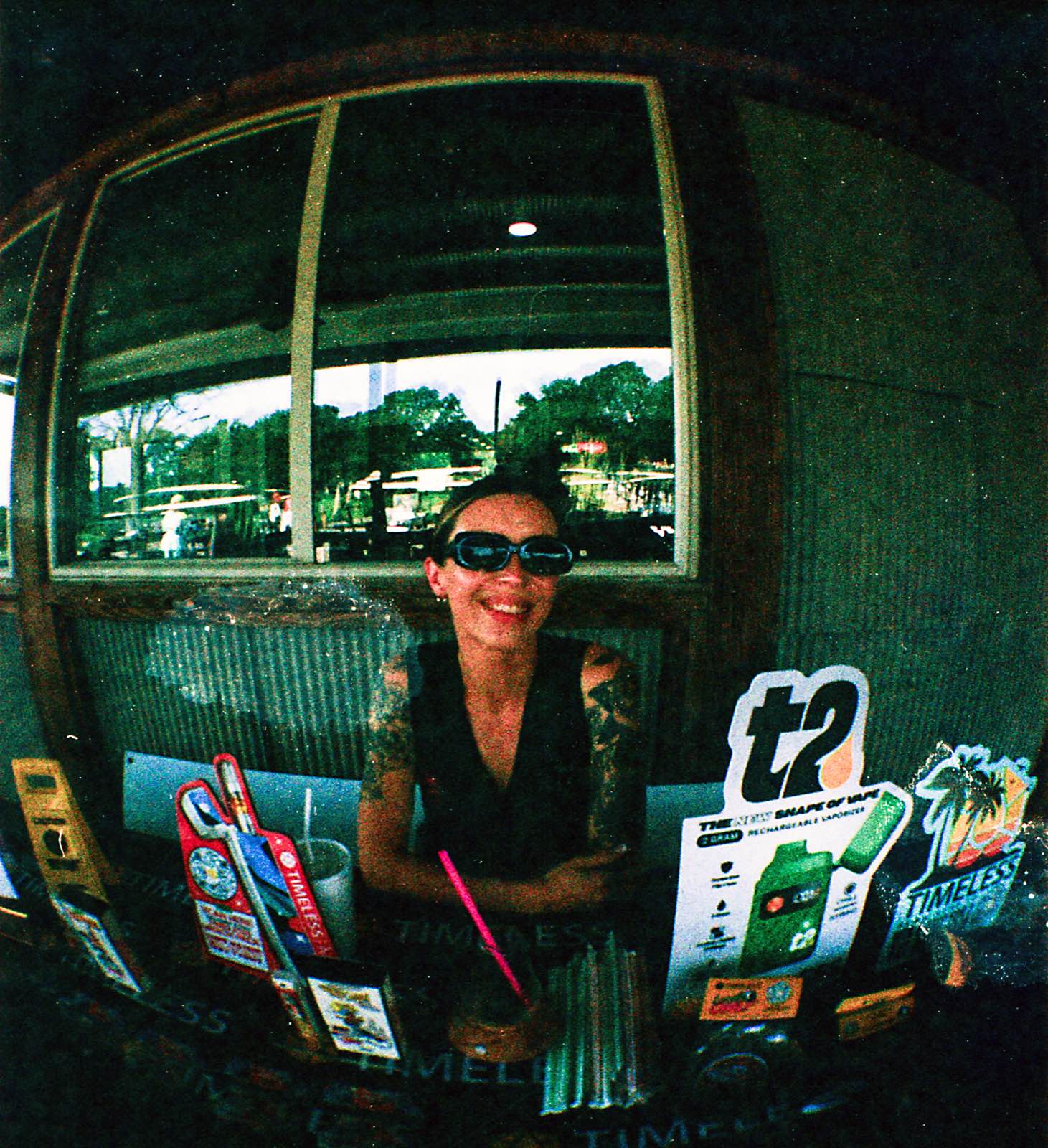 League member laughing behind the Timeless Cannabis signage at the clubhouse counter